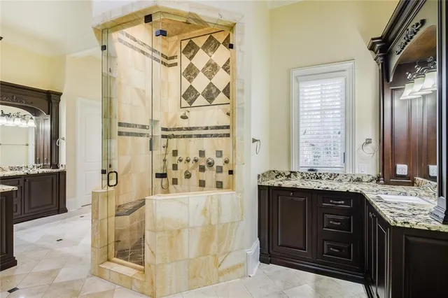 a spacious bathroom with a granite countertop tub and a mirror