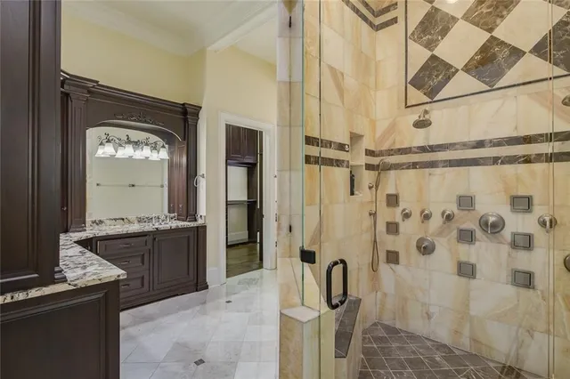 a bathroom with a granite countertop sink a toilet and shower