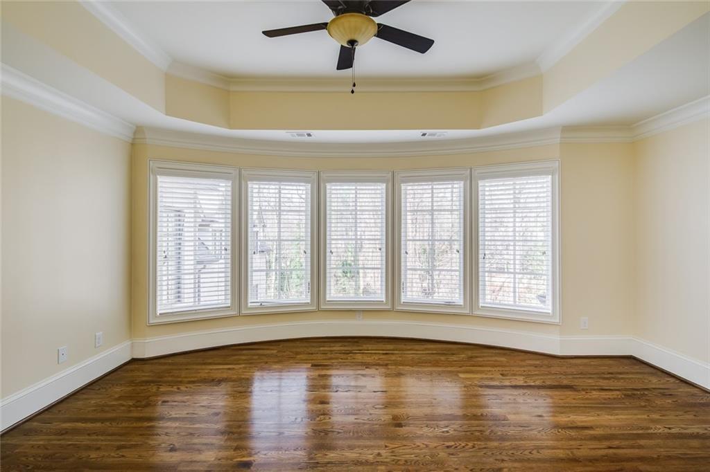 35 Mt Paran Road Northwest Sandy Springs, GA 30327 - Photo 32 of 61 a view of an empty room with window a ceiling fan and wooden floor