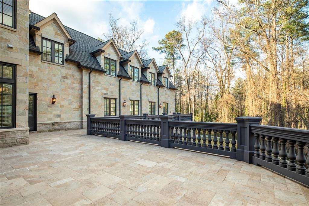 35 Mt Paran Road Northwest Sandy Springs, GA 30327 - Photo 51 of 61 a view of a brick house with a large tree and wooden fence