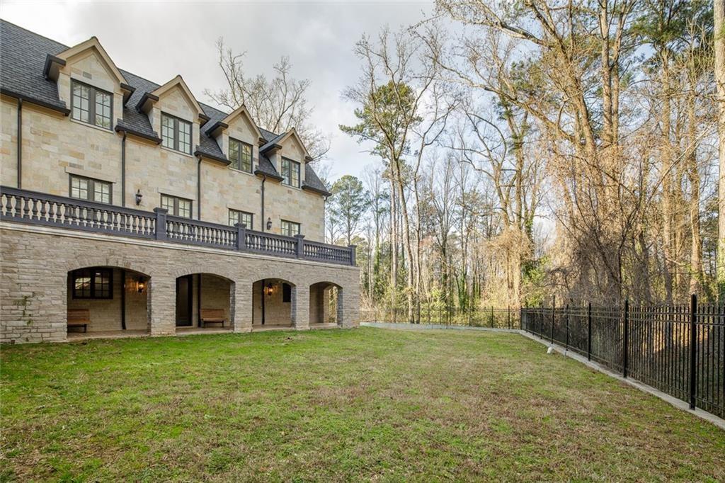 35 Mt Paran Road Northwest Sandy Springs, GA 30327 - Photo 58 of 61 a large white house with a large tree and a yard in front of it