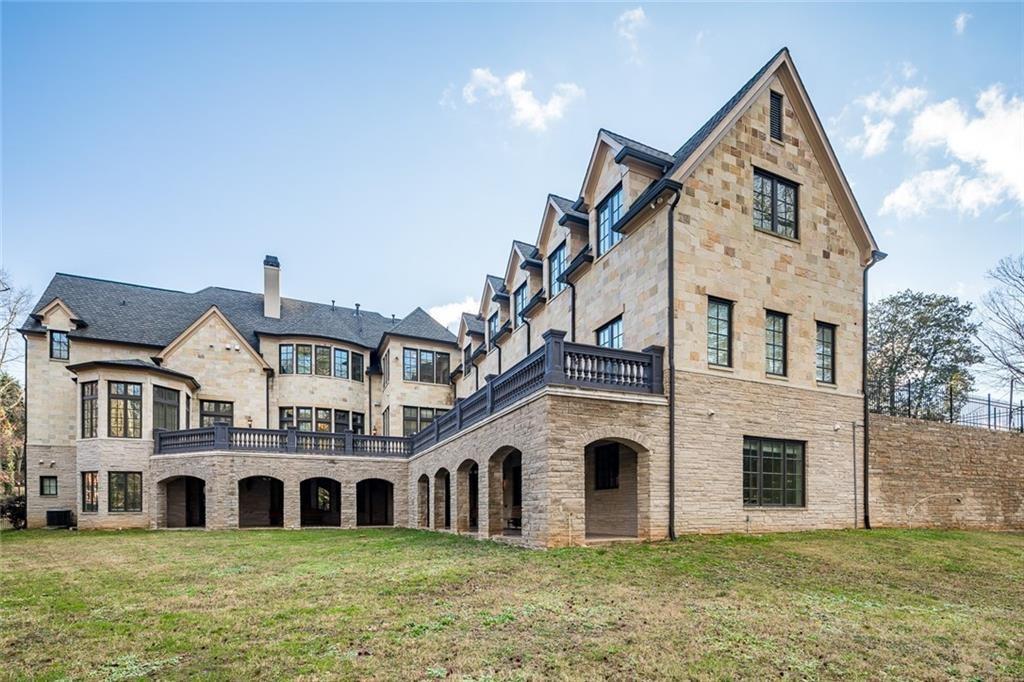 35 Mt Paran Road Northwest Sandy Springs, GA 30327 - Photo 59 of 61 a front view of a house with a yard and garage