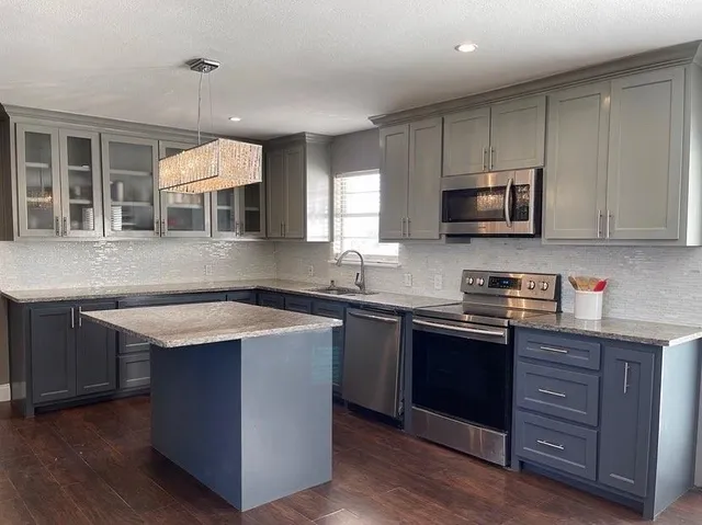 a kitchen with a sink stove and microwave