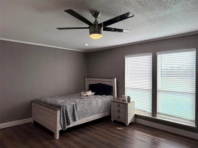a bedroom with a bed and a ceiling fan