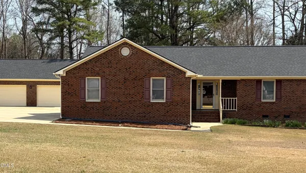 a house that has a tree in front of it