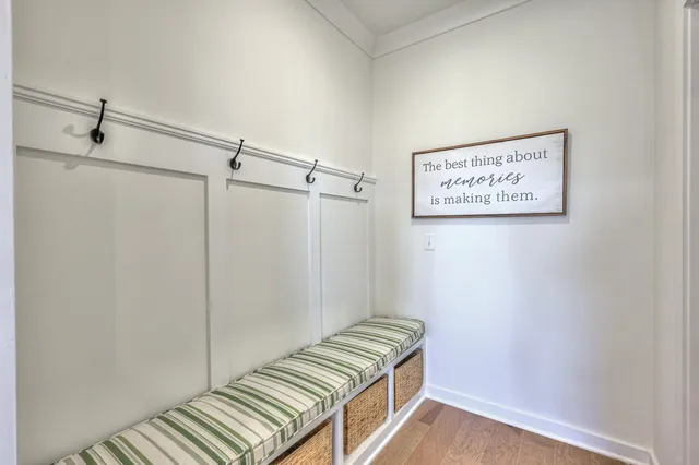 a view of a hallway with wooden floor and windows