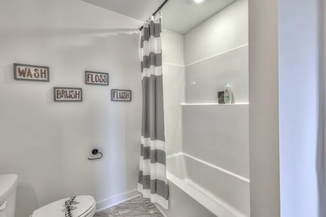 an aerial view of a house with yard