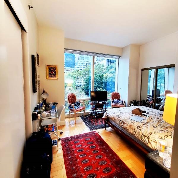 845 United Nations Plaza, Unit 5D Manhattan, NY 10017 - Photo 13 of 28 a living room with furniture rug and a large window