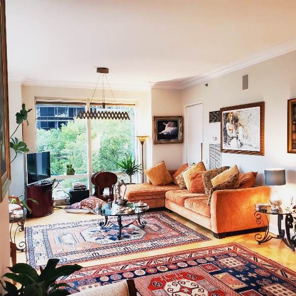 845 United Nations Plaza, Unit 5D Manhattan, NY 10017 - Photo 15 of 28 a living room with furniture fireplace and a large window