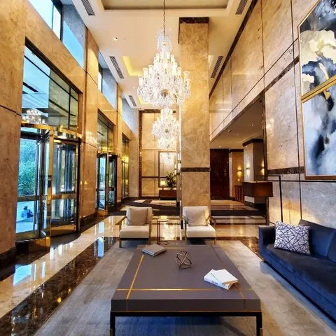 a living room with furniture fireplace and a large window