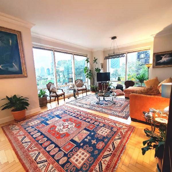 a living room with furniture a rug and a large window