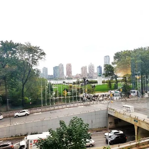 a living room with furniture a rug and a large window