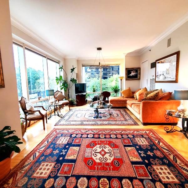 845 United Nations Plaza, Unit 5D Manhattan, NY 10017 - Photo 3 of 28 a living room with furniture a rug and a large window