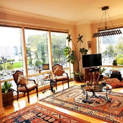 a living room with furniture a rug and a large window