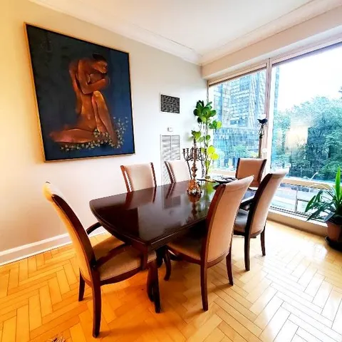 a living room with furniture large window and a flat screen tv