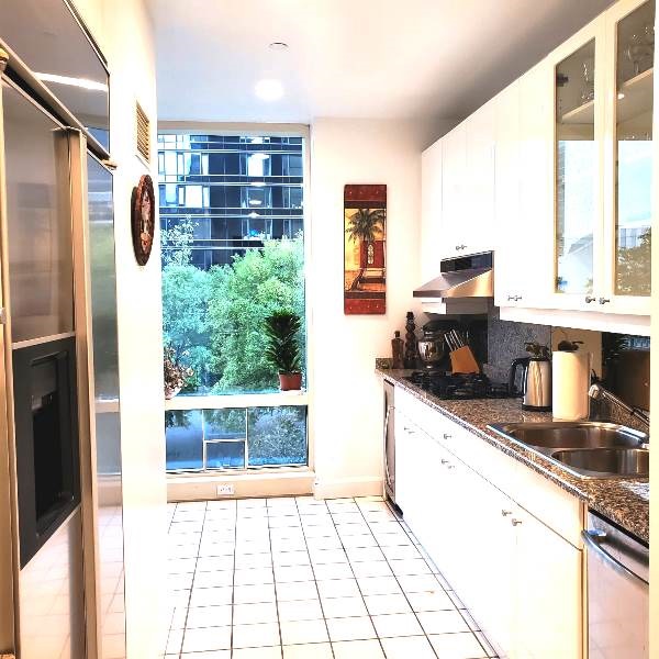 845 United Nations Plaza, Unit 5D Manhattan, NY 10017 - Photo 7 of 28 a kitchen with stainless steel appliances granite countertop a refrigerator and a sink