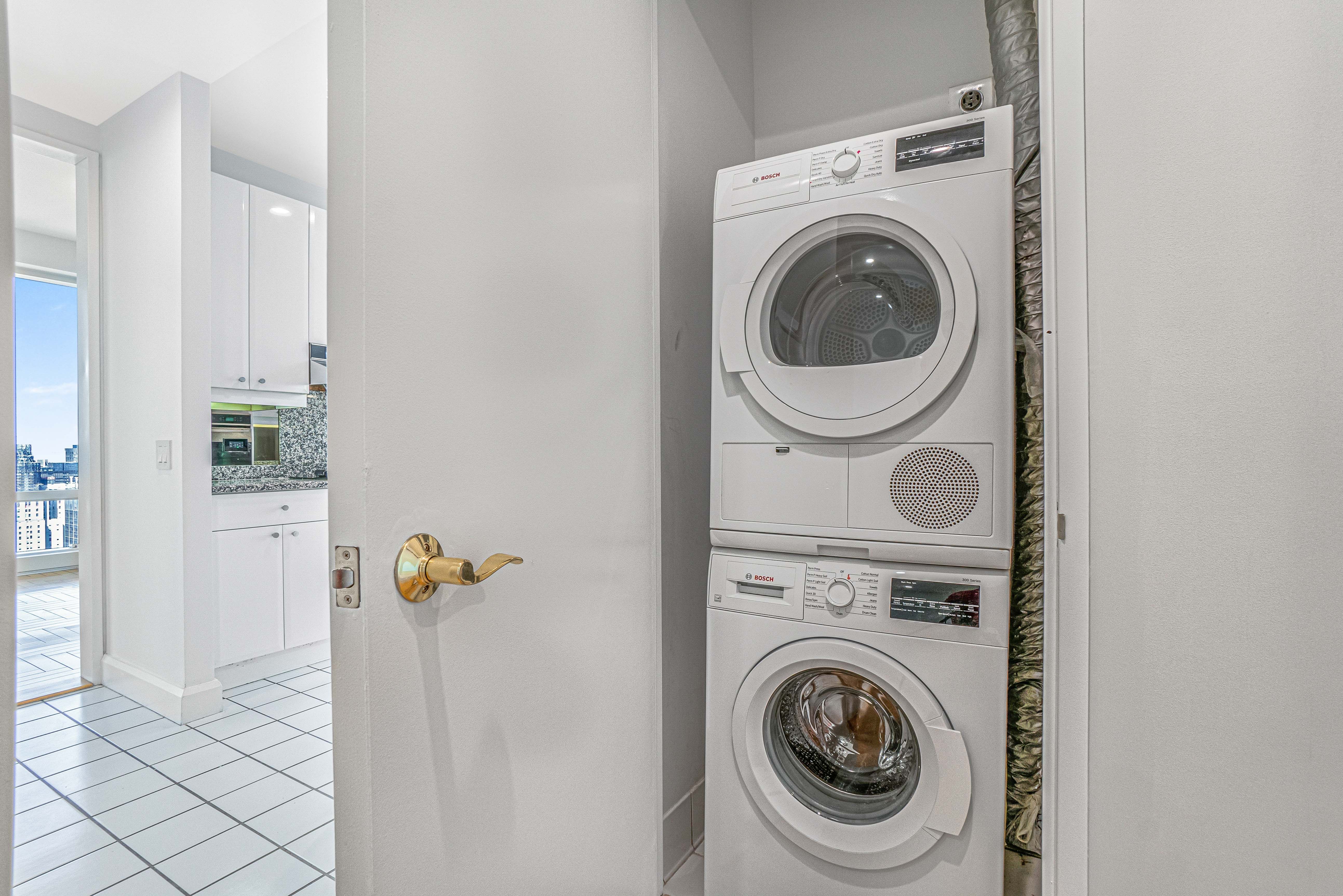 845 United Nations Plaza, Unit 5D Manhattan, NY 10017 - Photo 9 of 28 a utility room with dryer and washer