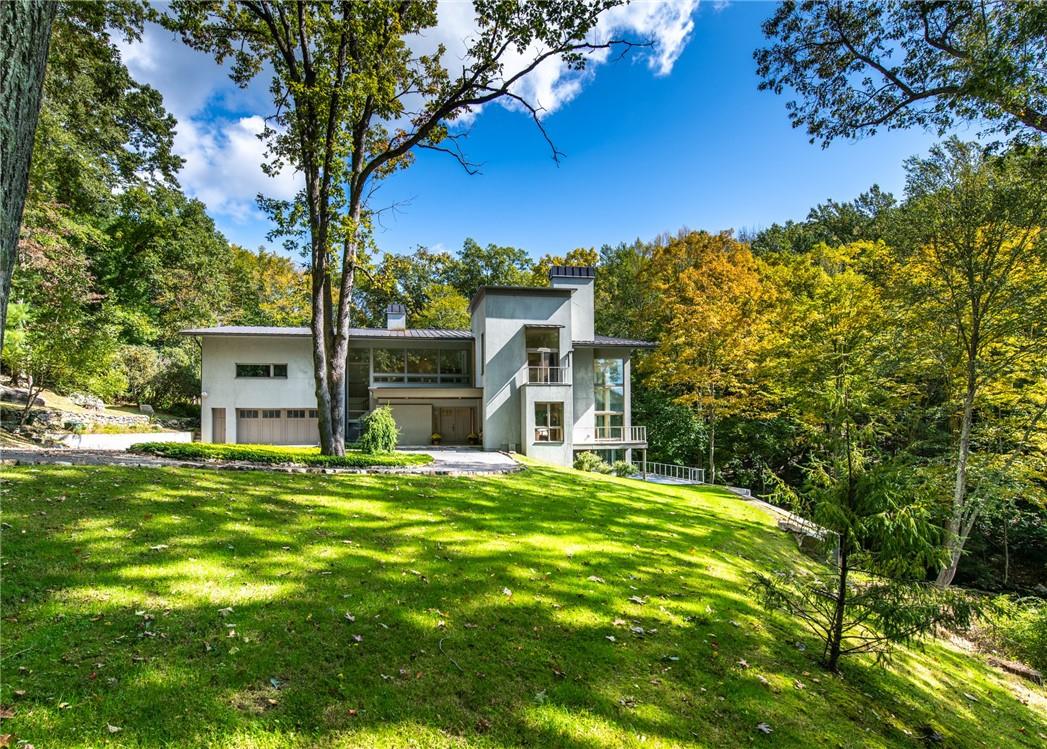 a front view of a house with a garden