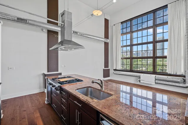 a kitchen with granite countertop a sink and a window