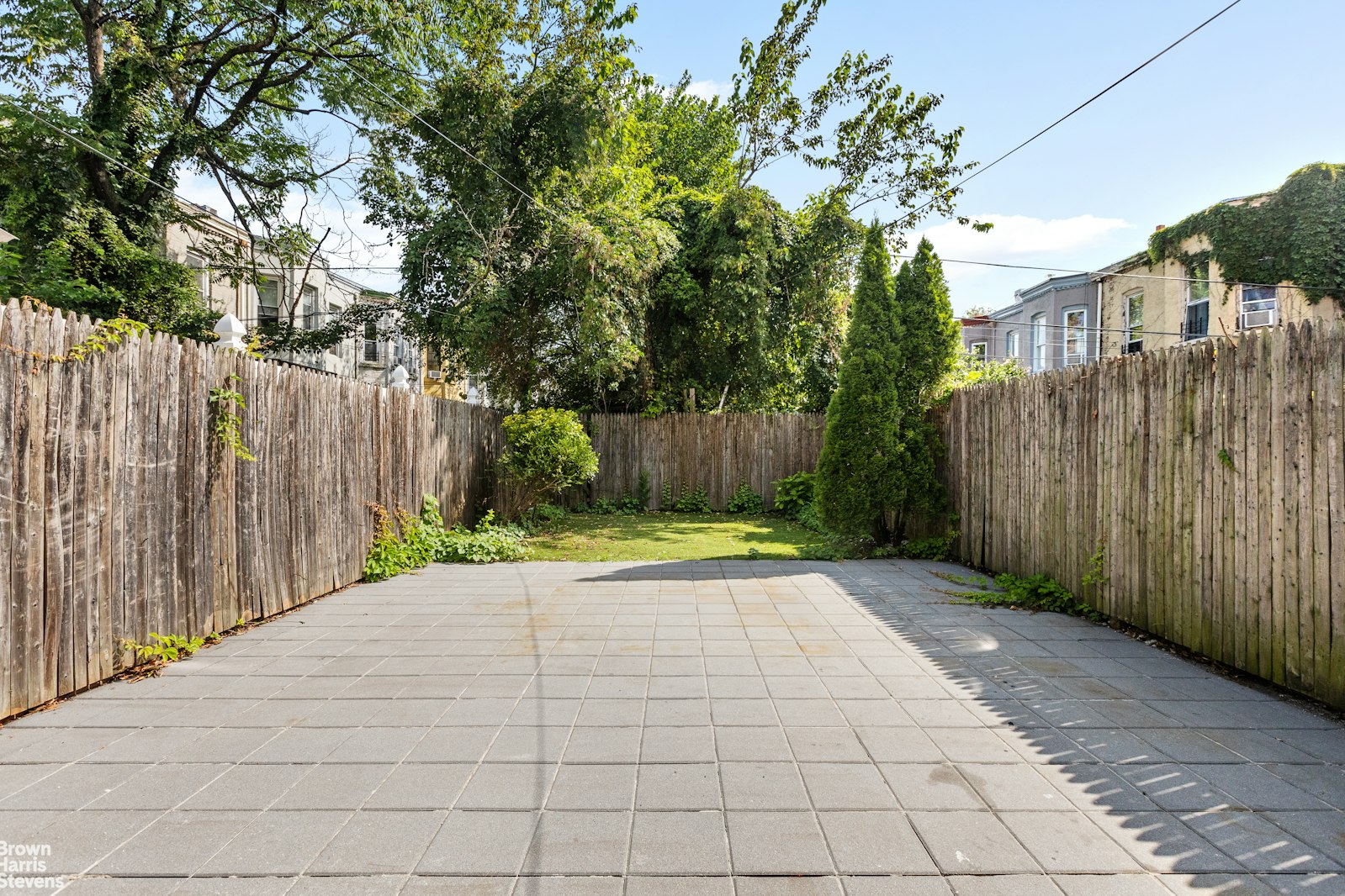 891 Knickerbocker Avenue Brooklyn, NY 11207 - Photo 10 of 12 a view of backyard with white fence