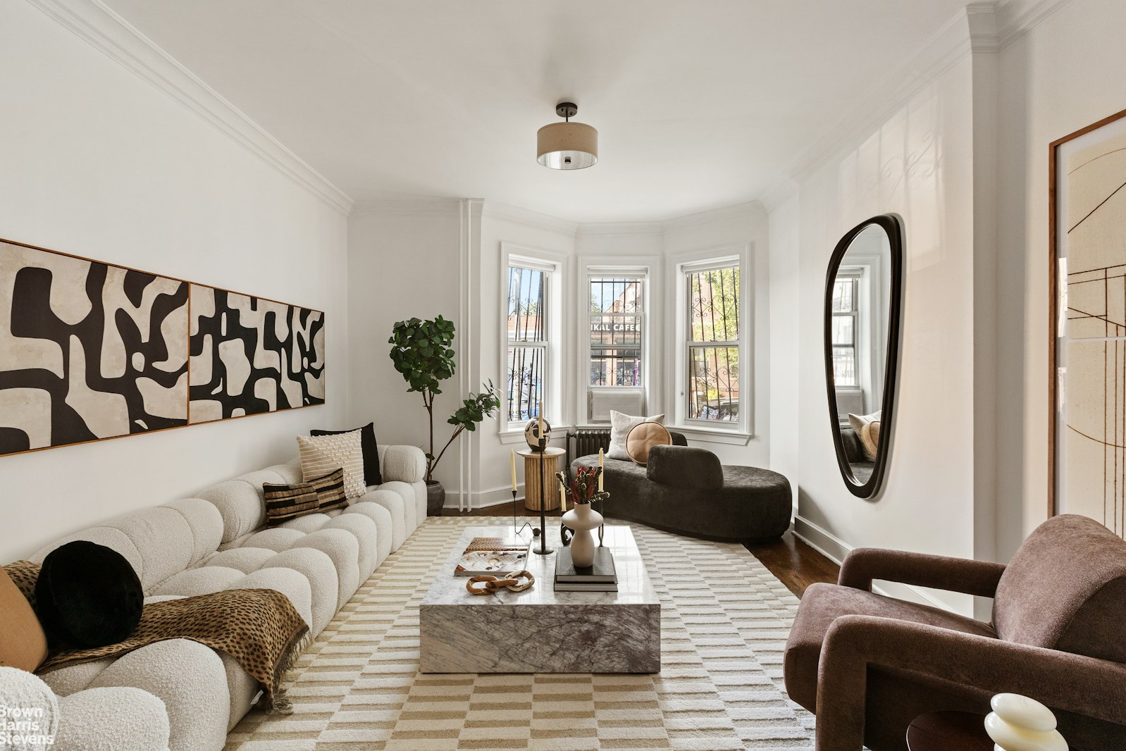 891 Knickerbocker Avenue Brooklyn, NY 11207 - Photo 2 of 12 a living room with furniture and a large window