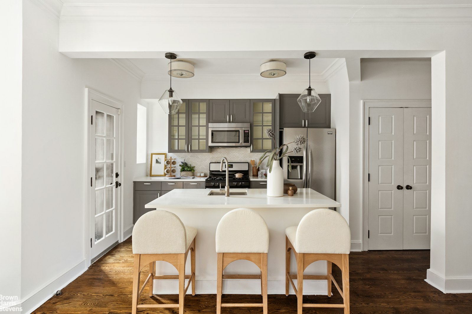 891 Knickerbocker Avenue Brooklyn, NY 11207 - Photo 3 of 12 a kitchen with stainless steel appliances granite countertop a refrigerator a stove top oven a sink dishwasher and white cabinets with wooden floor