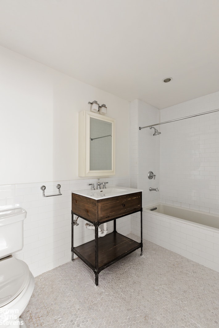 891 Knickerbocker Avenue Brooklyn, NY 11207 - Photo 9 of 12 a bathroom with a toilet a sink and bathtub
