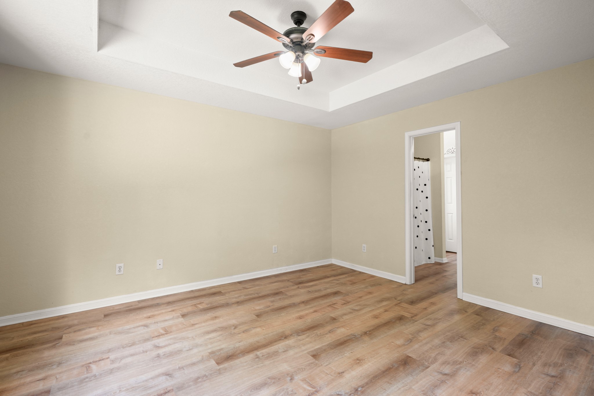 438 Katy Crossing Georgetown, TX 78626 - Photo 13 of 24 A spacious bedroom features warm hardwood-style flooring and a refreshing ceiling fan for comfort.