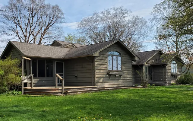 a view of brick house with a small yard