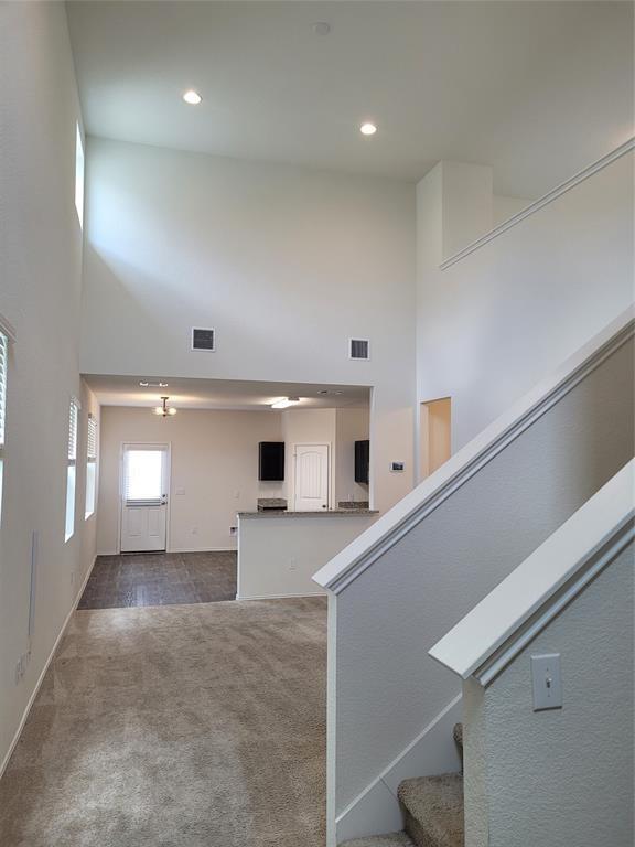 14917 Gypsum Mill Road Manor, TX 78653 - Photo 3 of 28 An airy great room offers seamless flow to a modern kitchen, enhanced by recessed lighting and high ceilings.