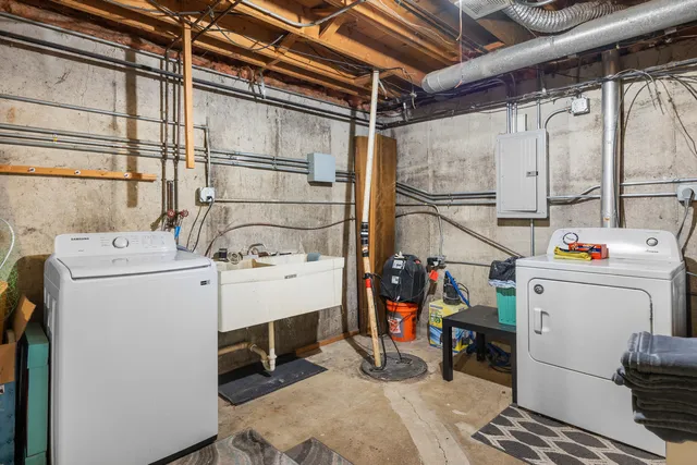 an aerial view of a residential houses with outdoor space and trees