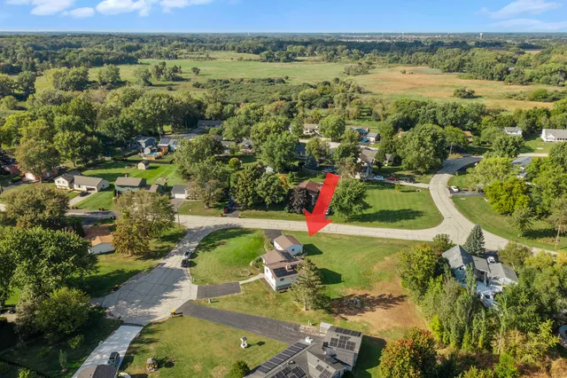 an aerial view of residential houses with outdoor space and river