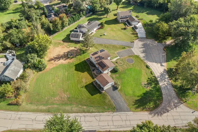 a view of a house with yard and a garden