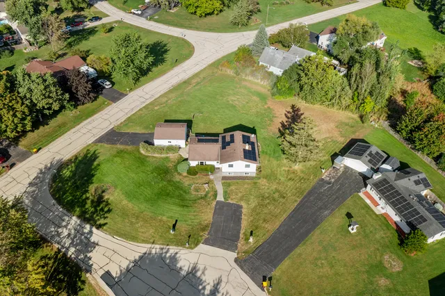 an aerial view of a house with a yard and plants