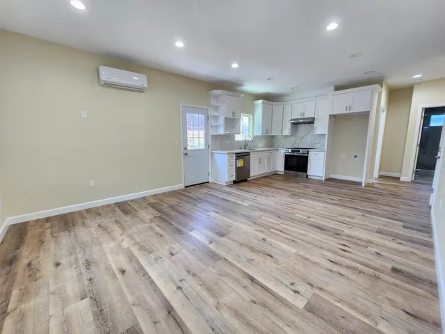 a view of kitchen with cabinets and wooden floor