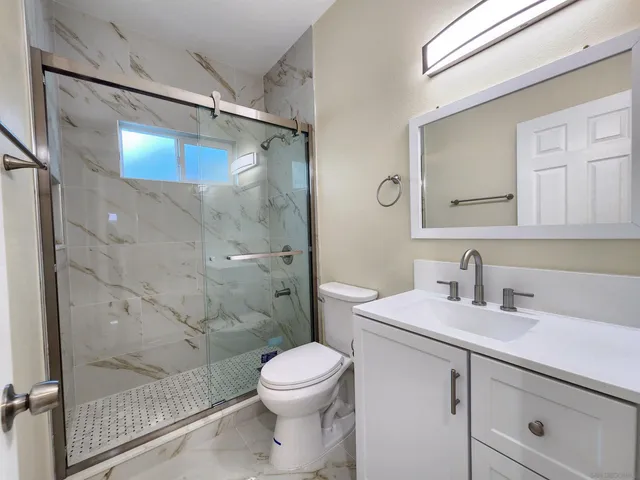 a bathroom with a sink toilet and shower
