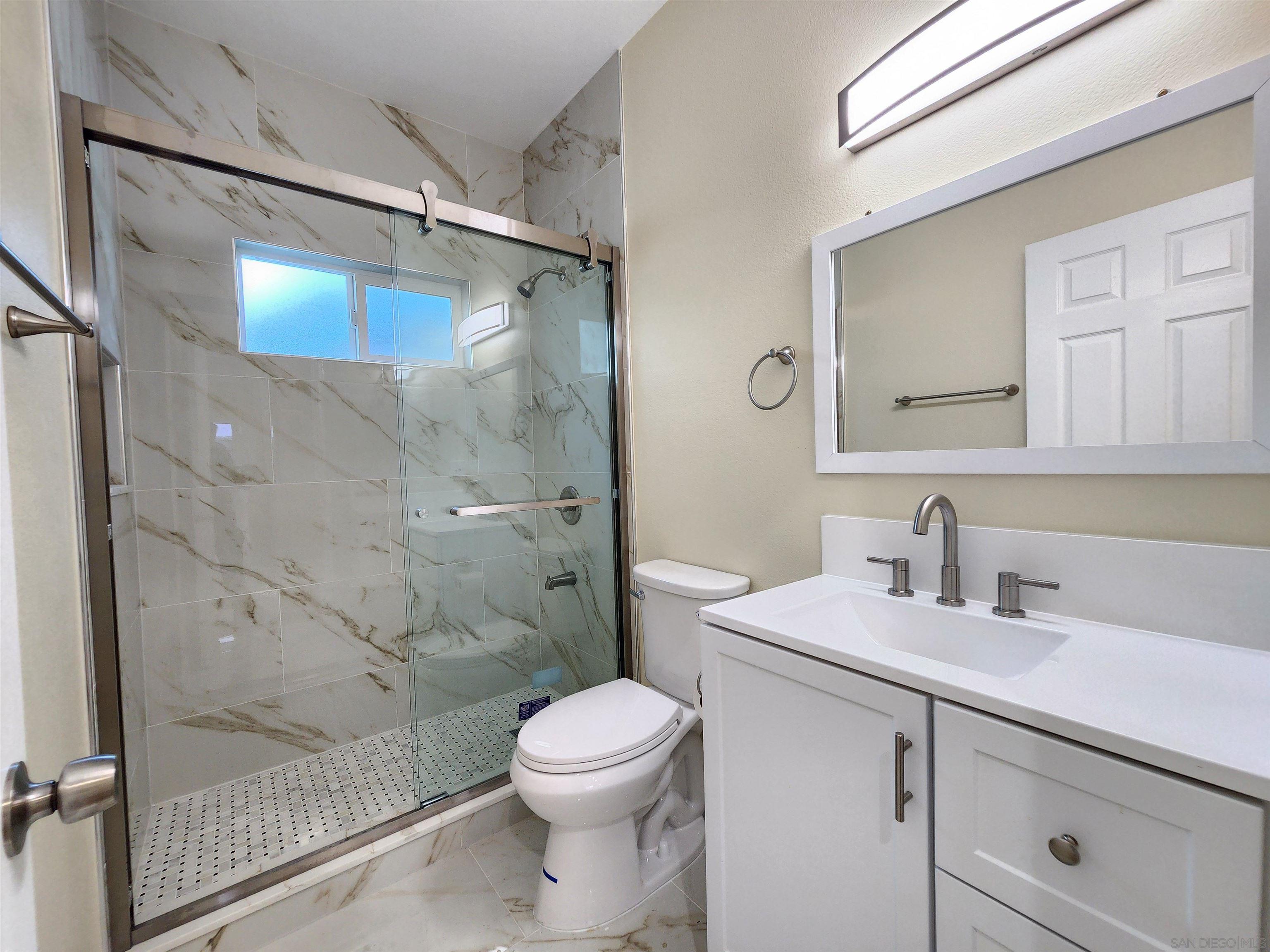 0 4024-4026 College Avenue San Diego, CA 92115 - Photo 16 of 20 a bathroom with a sink toilet and shower