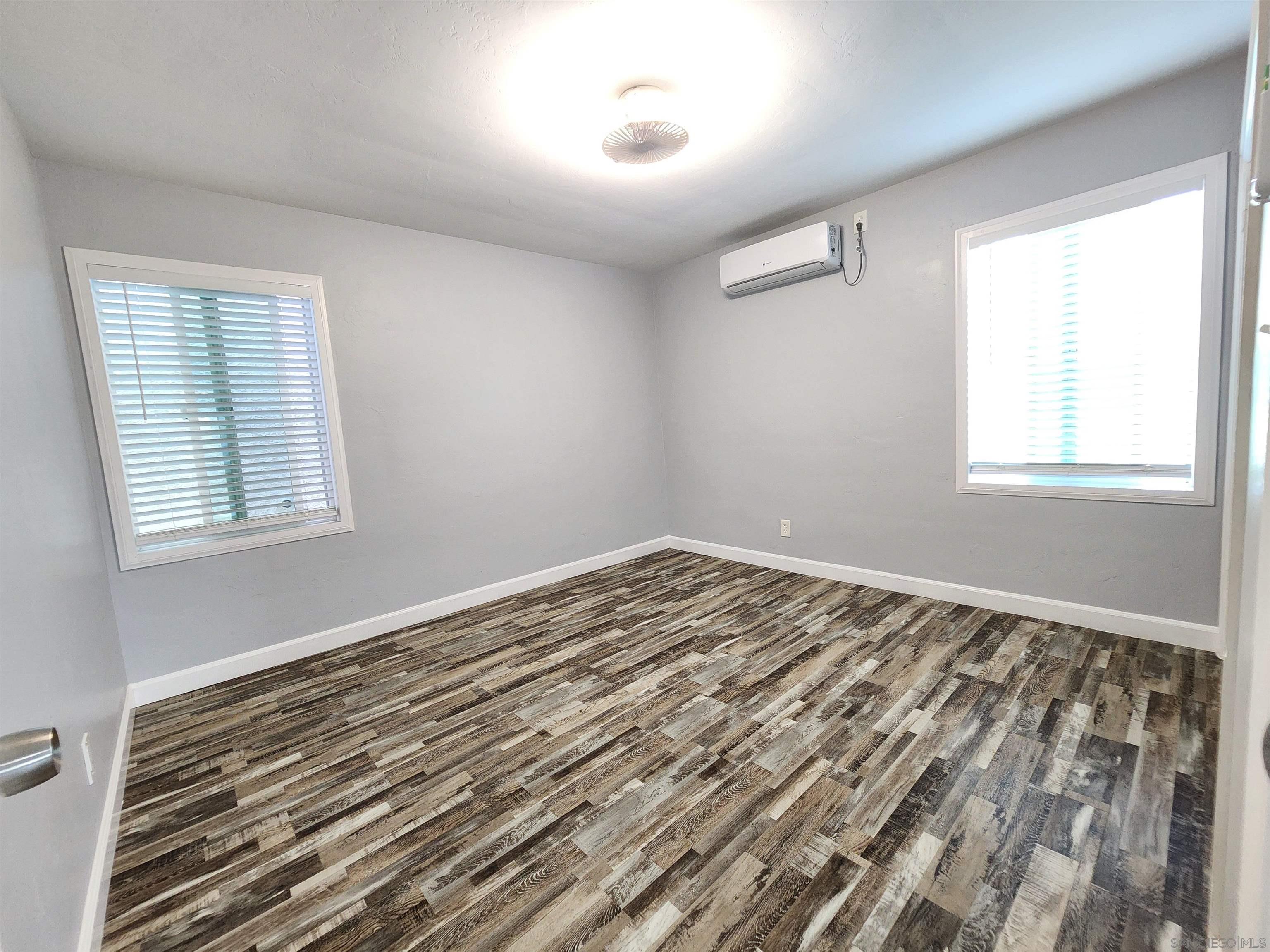 0 4024-4026 College Avenue San Diego, CA 92115 - Photo 7 of 20 a view of a room with wooden floor and windows