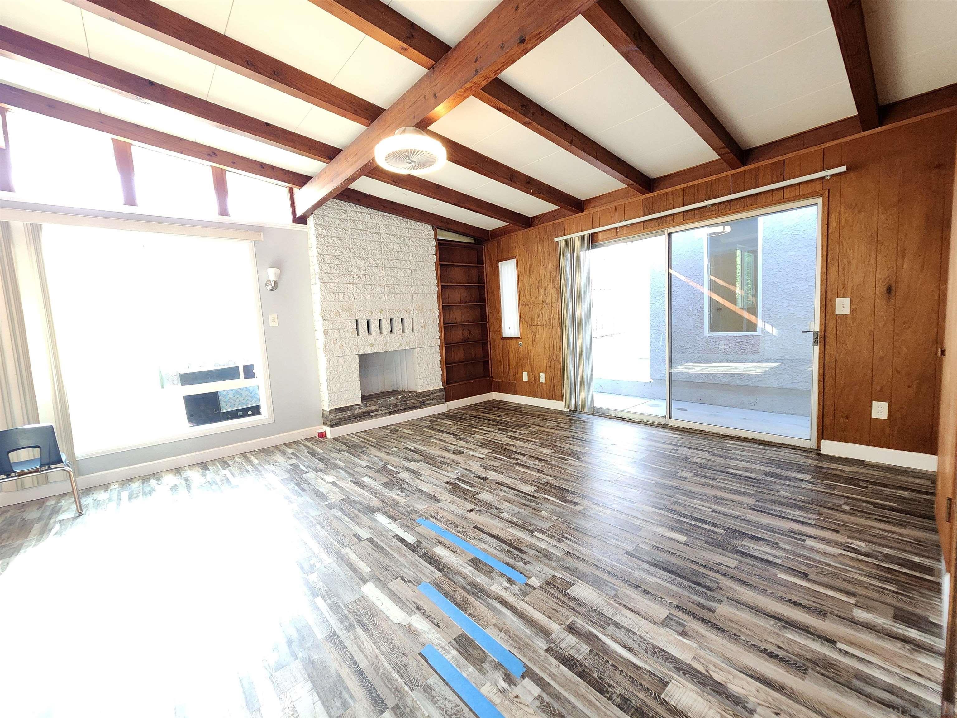 0 4024-4026 College Avenue San Diego, CA 92115 - Photo 10 of 20 a view of an empty room with wooden floor and a window