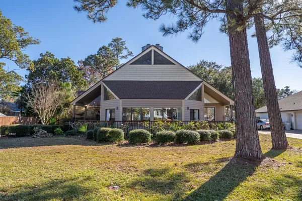 a front view of house with yard and trees around