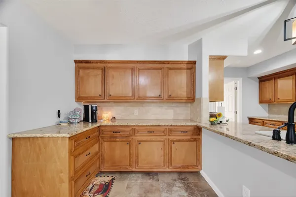 a kitchen with a sink stove and cabinets