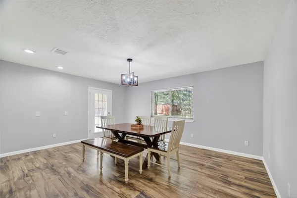 a view of a dining room with furniture and wooden floor