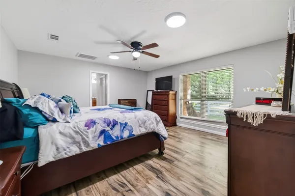 a bedroom with a large bed and a large window