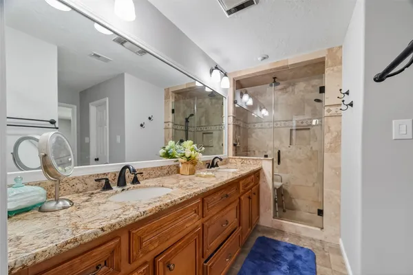 a bathroom with a granite countertop sink mirror and double