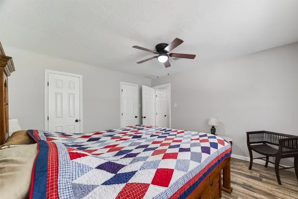a bedroom with a bed and a chandelier