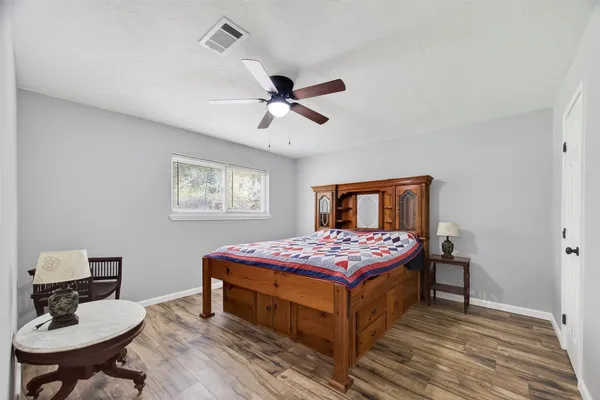 a bedroom with a bed and a table in it