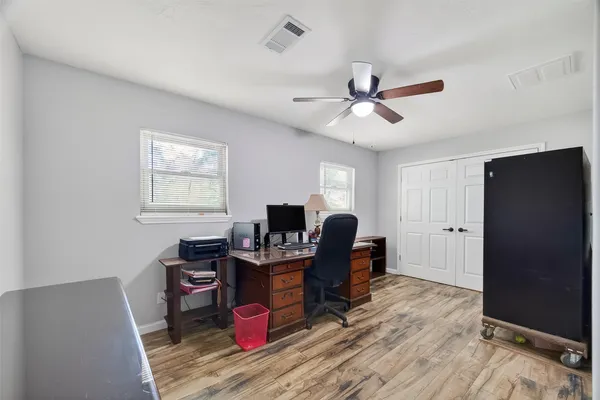 a view of a workspace with furniture and a window