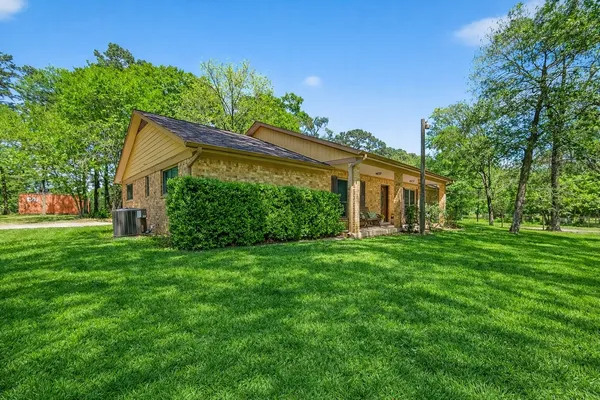 a view of a house with yard and a garden