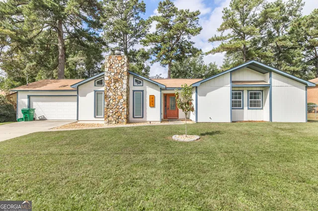a front view of a house with a garden