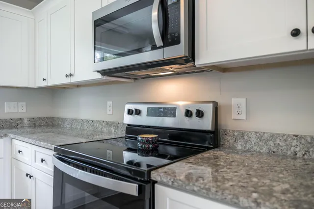 a kitchen with a stove and a microwave